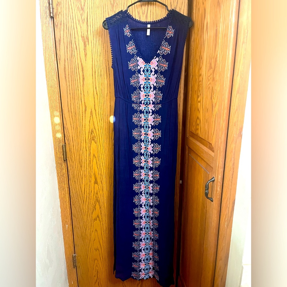 Blue maxi dress with intricate stitching details along shoulders and neckline